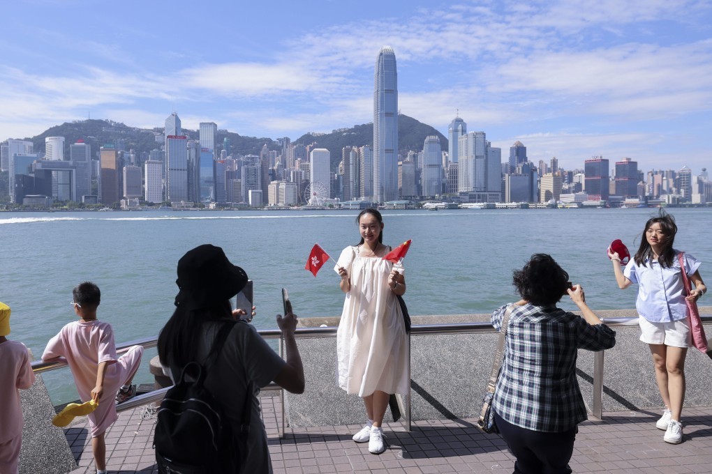 Visitors take pictures in Tsim Sha Tsui during the National Day “golden week” holidays. Photo: Nora Tam