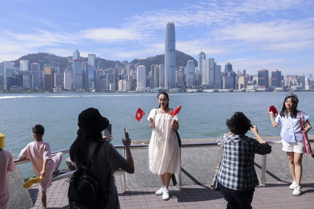 Visitors take pictures in Tsim Sha Tsui during the National Day “golden week” holidays. Photo: Nora Tam