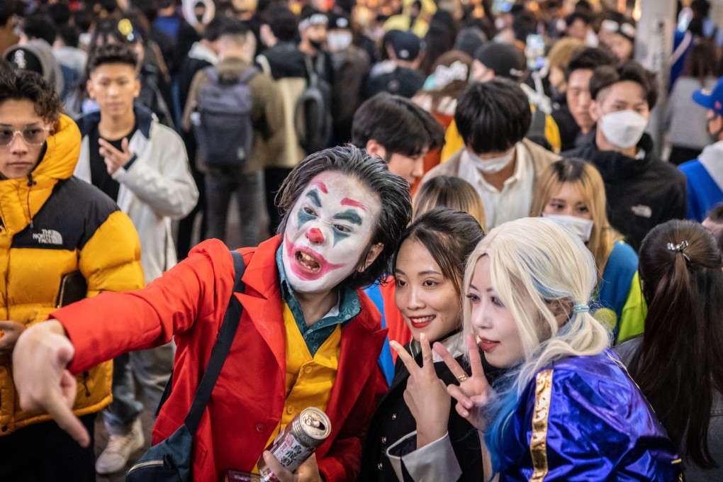 People wearing costumes pose for photographs in the Shibuya district of Tokyo at Halloween. Photo: AFP