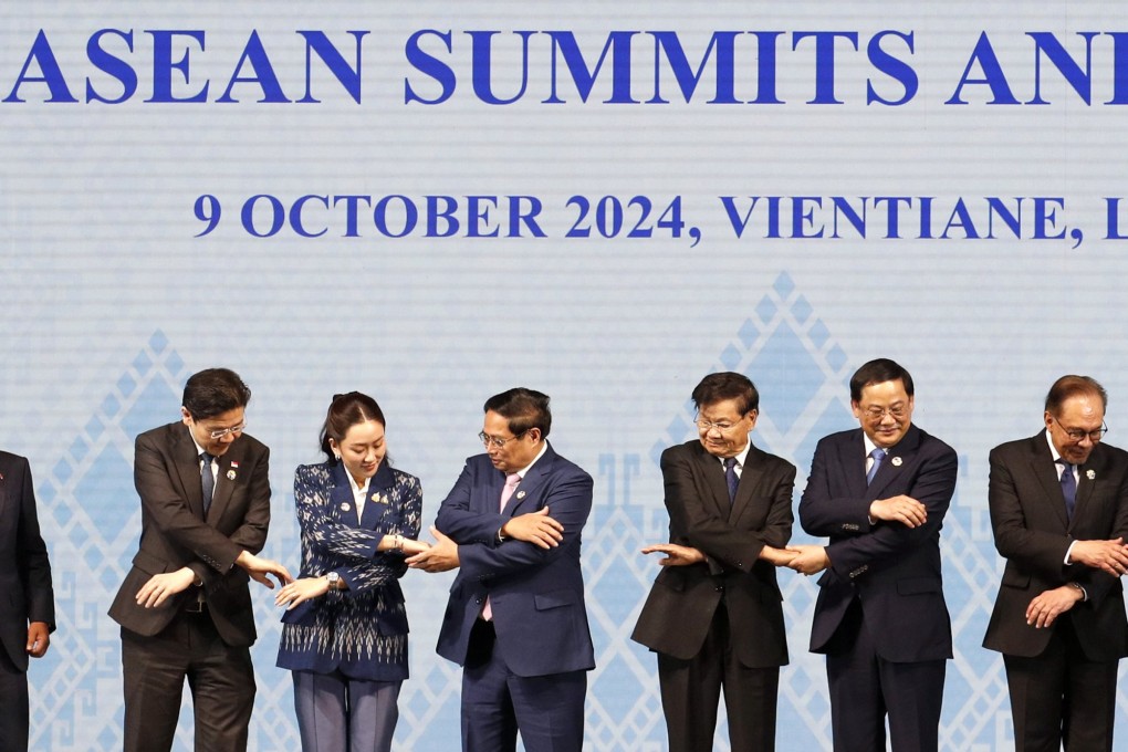 Asean leaders reach for each other’s hands during a group photo at the opening ceremony of the Asean Summit in Vientiane, Laos, on Wednesday. Photo: EPA-EFE