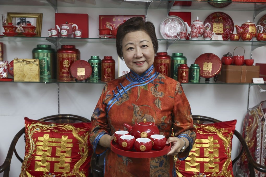 Lo Kan-fong, a “bride’s chaperon” for Chinese weddings, with a tea set that typically forms part of the bride’s dowry. Photo: Edmond So