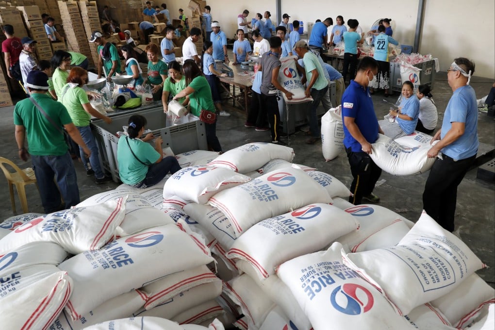 Filipino volunteers from Church of God International repack relief goods at a government storage facility in Pasay, the Philippines, in 2017. Photo: EPA-EFE