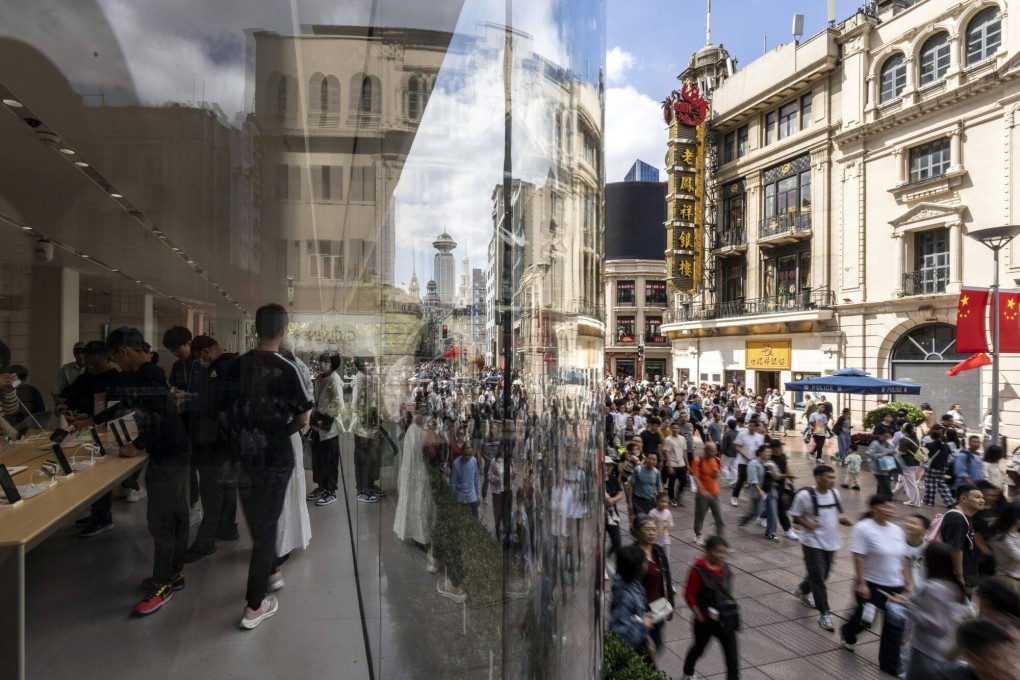 Shoppers pass a Huawei store on Nanjing East Road in Shanghai, on October 2. Restoring consumer confidence and furthering a shift to an economy based more on domestic consumption were among the primary goals of Beijing’s recent stimulus measures. Photo: Bloomberg