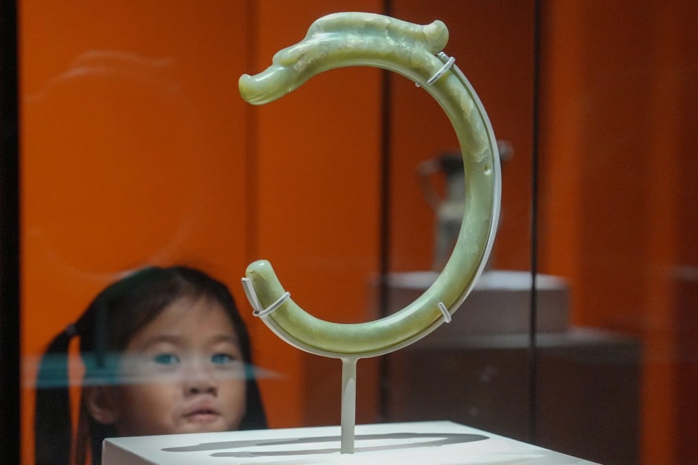 A C-shaped jade dragon dating back to between 5,000 and 6,000 years ago is displayed at the “The Origins of Chinese Civilisation” exhibition at the Hong Kong Palace Museum. The item, a grade-one national treasure, is one of more than 100 ancient artefacts on display. Photo: May Tse