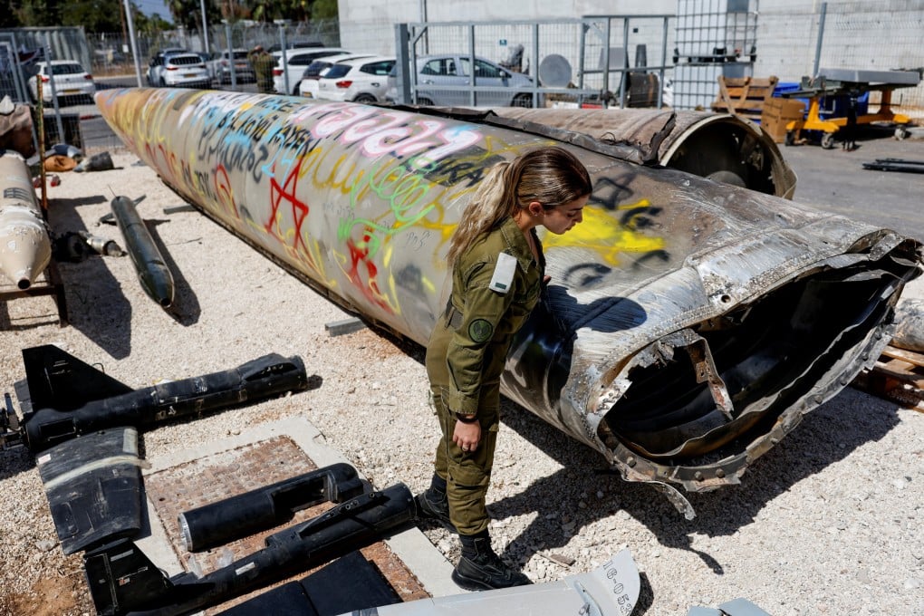 An Israeli soldier next to the remains of an Emad ballistic missile, after an attack by Iran on Israel. Photo: Reuters