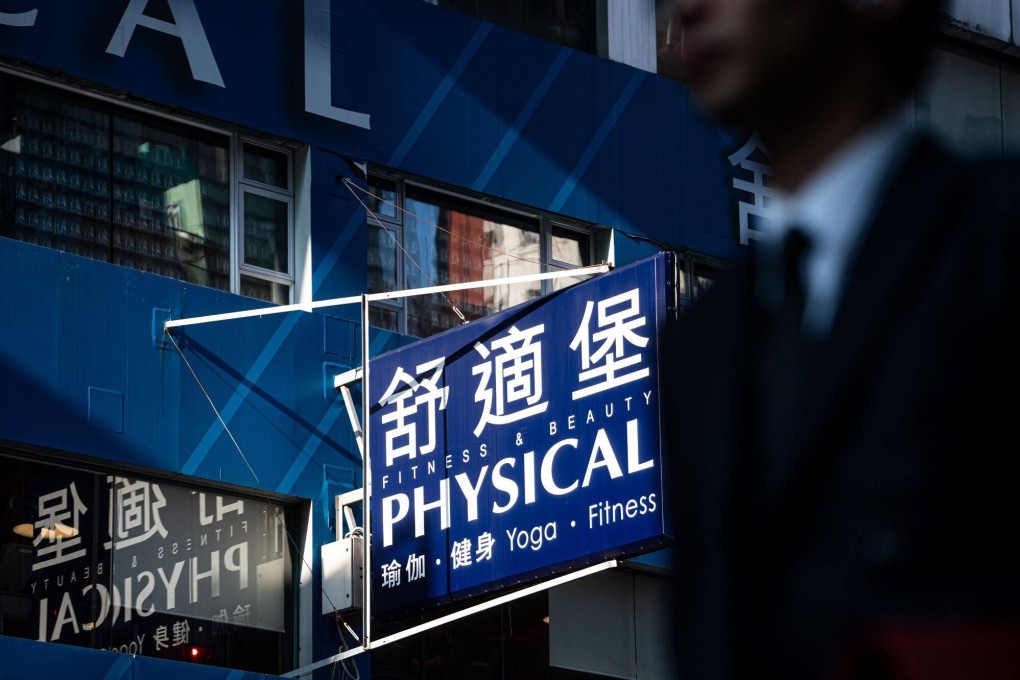 Signage for a Physical Fitness gym is seen in Hong Kong on September 27. When companies struggle financially, the staff and creditors are usually the first ones to spot the signs. Photo: Bloomberg
