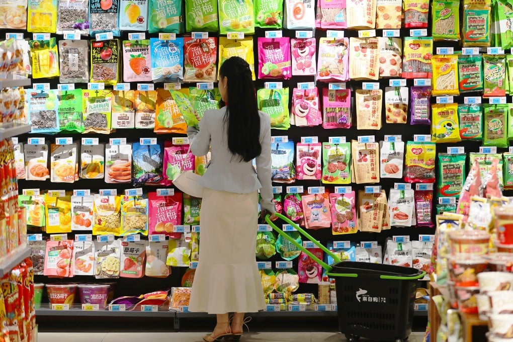 A shopper examines goods at a supermarket in Tengzhou, Shandong province, on April 11. Photo: Xinhua