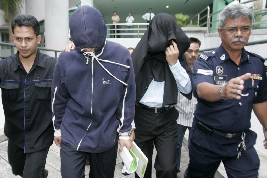Policemen Azilah Hadri and Sirul Azhar Umar arrive at the courthouse in Shah Alam outside Kuala Lumpur in 2009. Photo: Reuters
