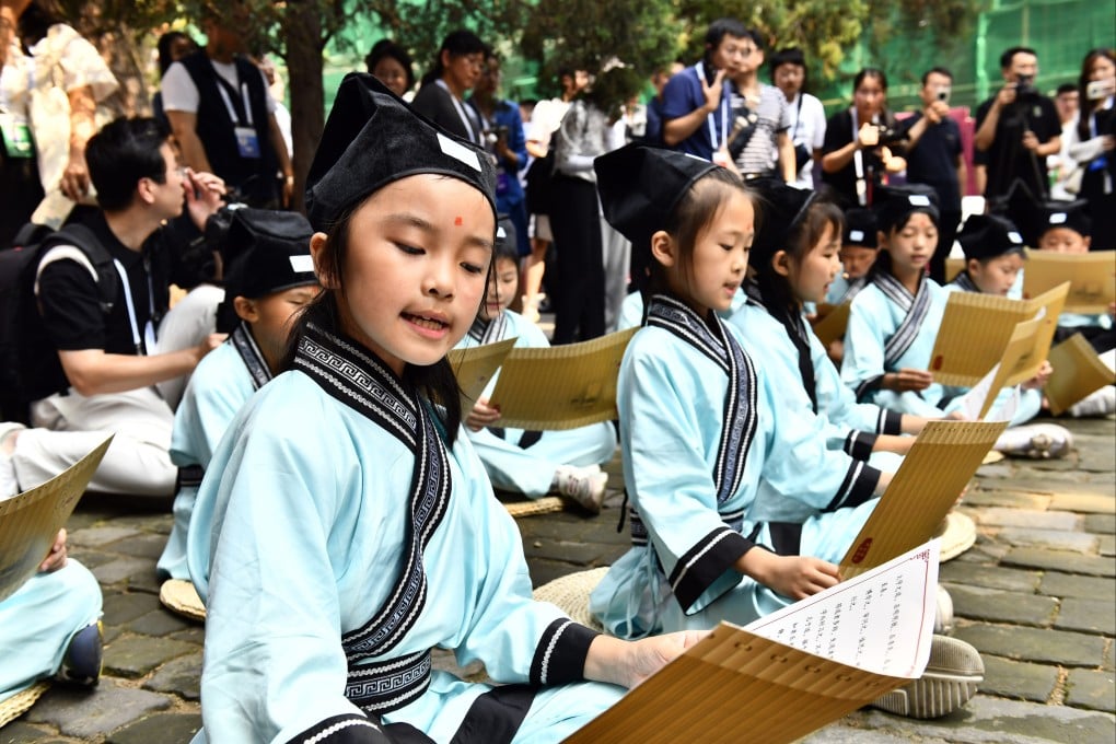 Children read the Analects at the Temple of Confucius in Qufu, Shandong province, on June 27, 2023. Photo: Xinhua