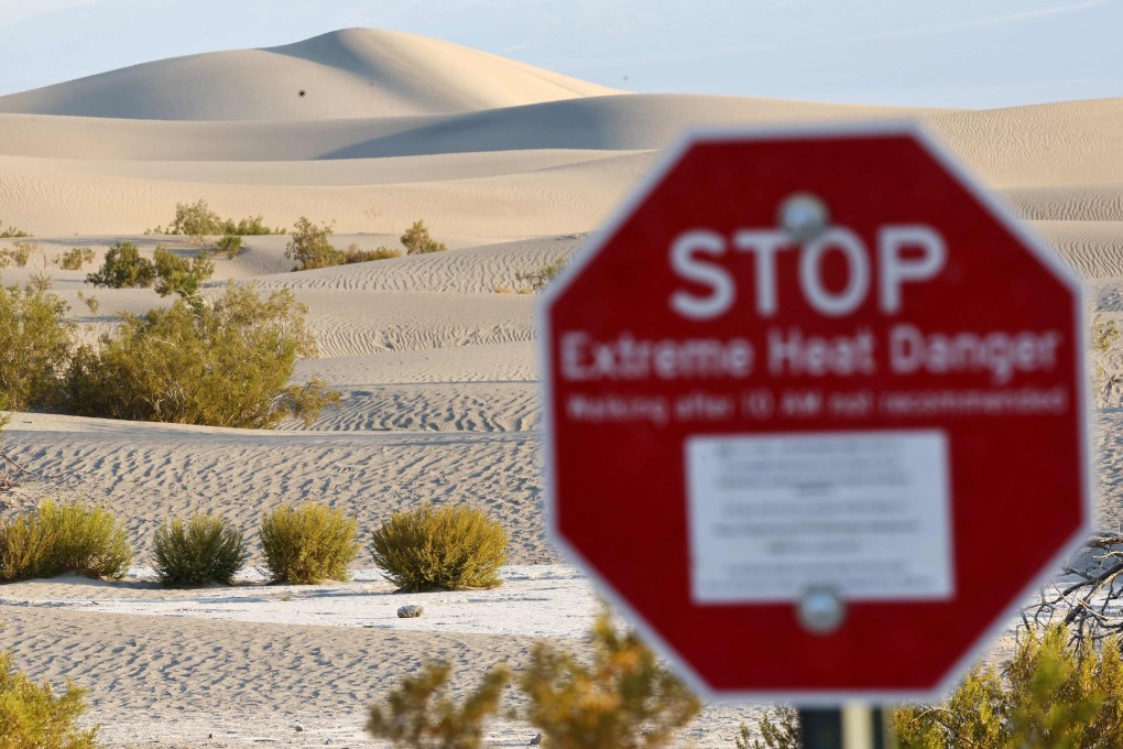 A sign is seen at Mesquite Flat Sand Dunes in Death Valley National Park during a heat wave that affected much of California, on July 9. Photo: Getty Images via AFP