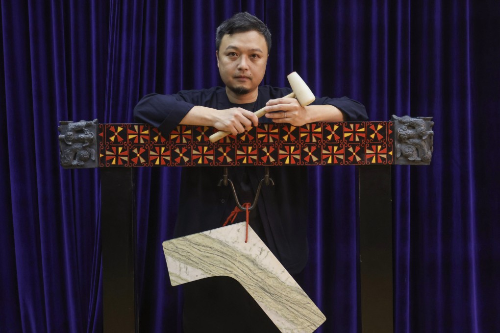 Hong Kong Chinese Orchestra member Luk Kin-bun with a lithophone. Made of stone and struck with a wooden mallet to produce sounds, the Chinese musical instrument. has a long history. Photo: Jonathan Wong