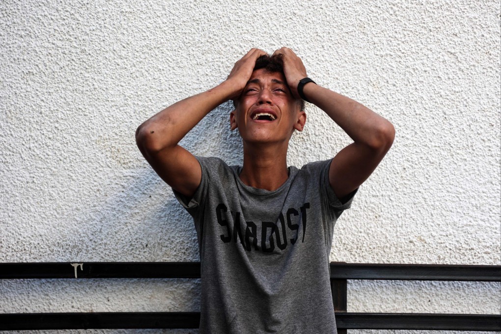 A Palestinian boy upon seeing the bodies of relatives killed in an overnight Israeli airstrike in the Jabilia refugee camp in the northern Gaza Strip, in front of the al-Maamadani on Saturday. Photo: AFP