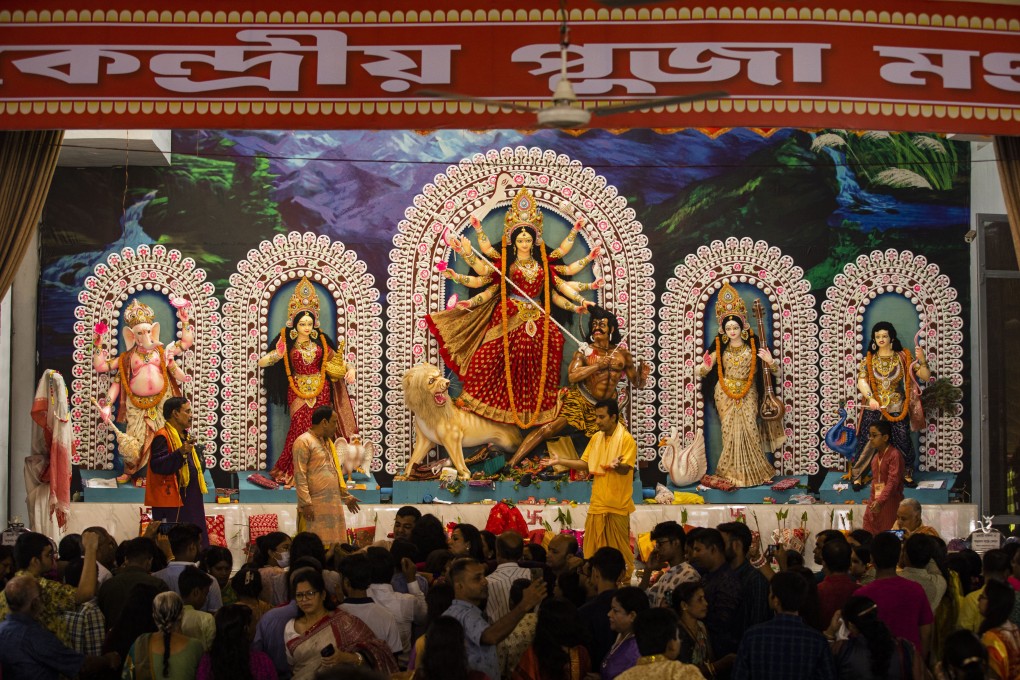 A tableau depicting the slaying of demon Mahishasura by the Hindu goddess Durga, center, is installed with other gods at Dhakeshwari National Temple during the Durga Puja festival in Dhaka, Bangladesh, on Thursday. Photo: AP