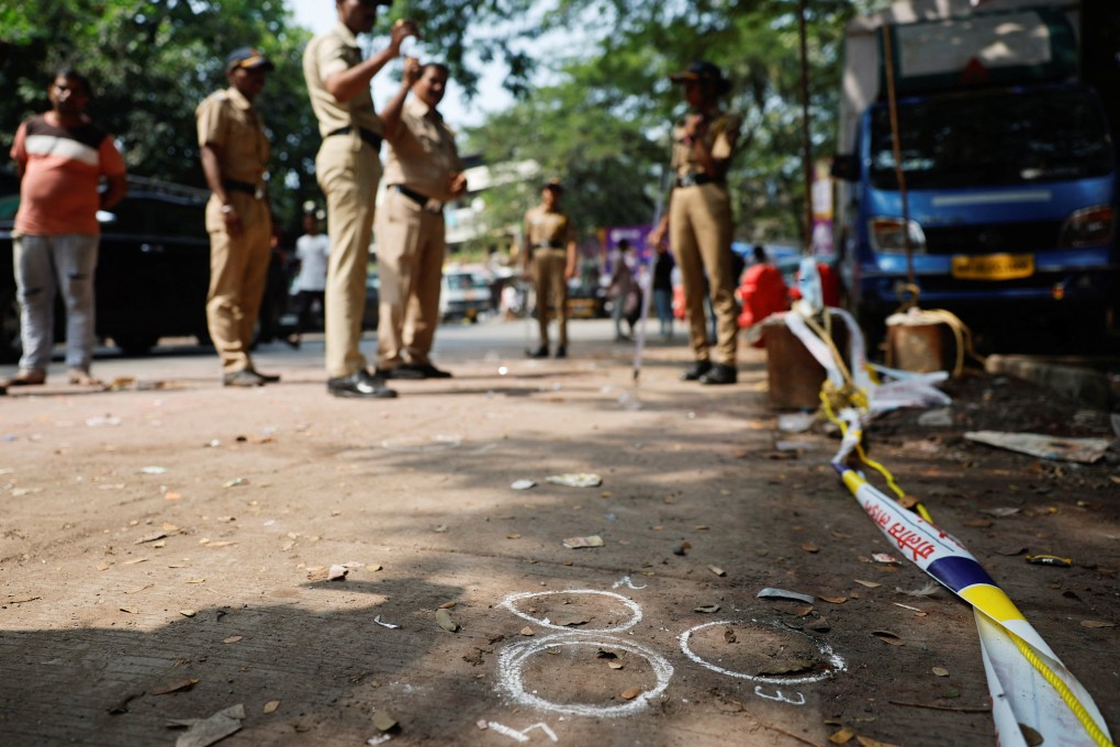 Police officers stand at the crime scene next to markings of the gunshots where Nationalist Congress Party (NCP) politician Baba Siddique was shot dead in Mumbai. Photo: Reuters