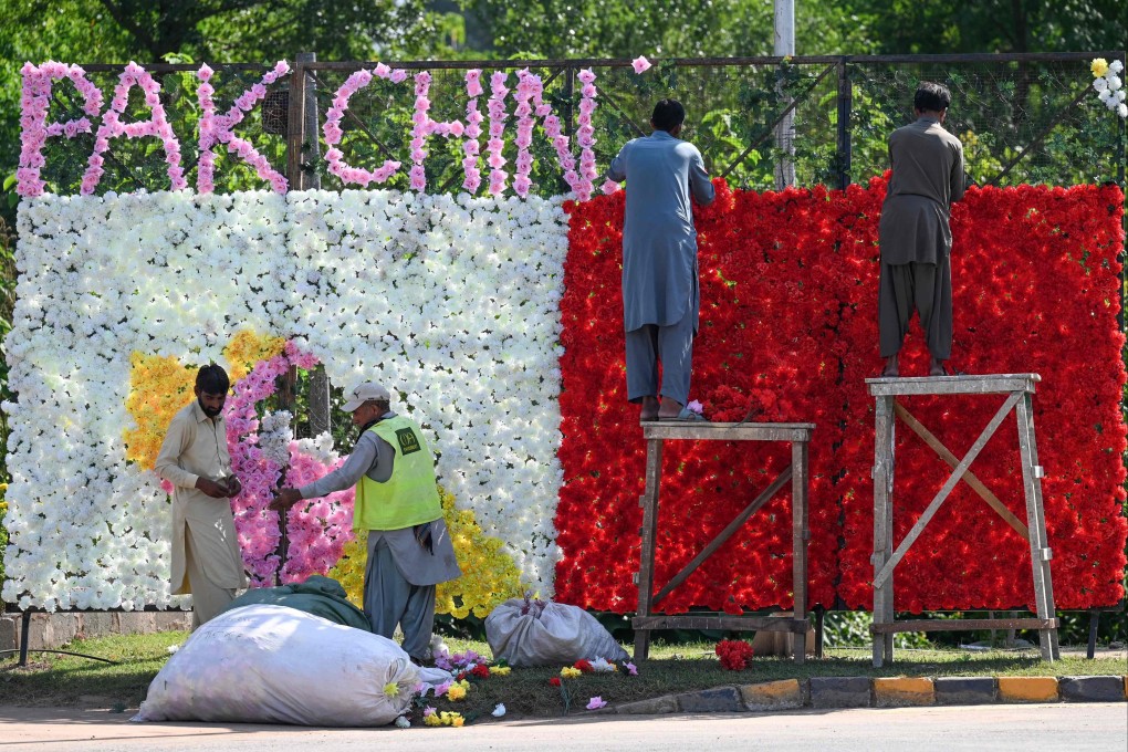 Workers decorate a street ahead of the Shanghai Cooperation Organisation (SCO) summit in Islamabad, on Sunday. Photo: AFP