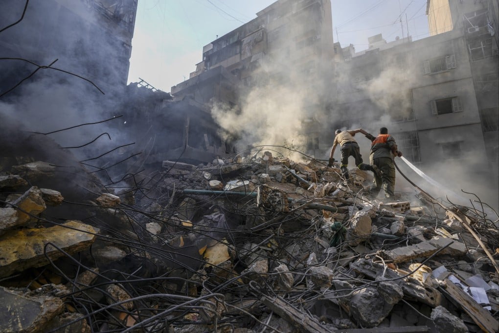 Rescuers search for victims at the site of an Israeli air strike in Beirut, Lebanon, on Friday. Photo: AP