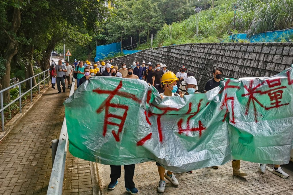 About 30 workers staged a protest at the site of the Hong Kong University of Science and Technology project, displaying a banner that read: “unpaid toil and sweat”. Photo: HKCIEGU