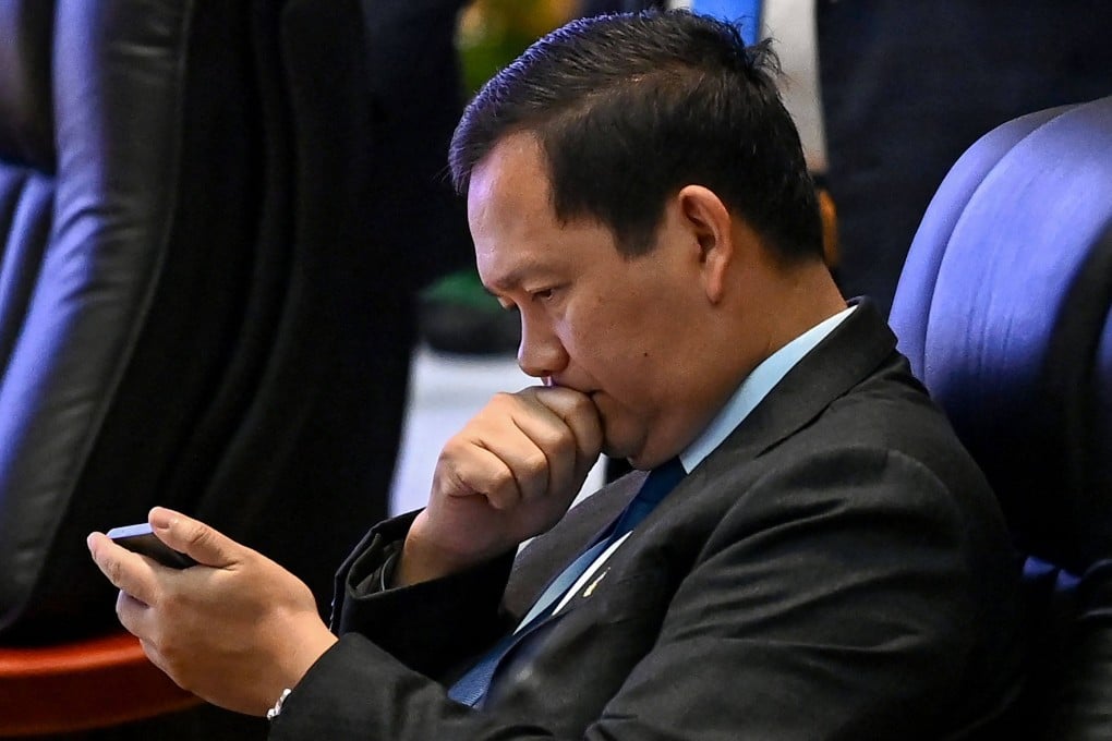 Cambodia’s Prime Minister Hun Manet looks at a phone at the Asean summit in Vientiane on Friday. Photo: AFP