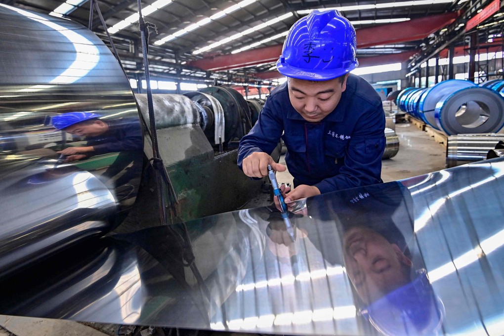 An employee works at a factory producing stainless steel materials in Qingzhou, in eastern Shandong province, on October 13. Photo: AFP