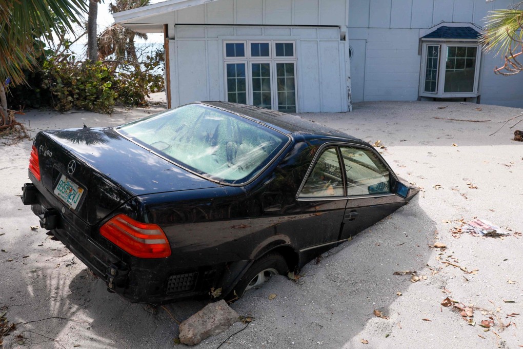 A vehicle sits stuck in beach sand in Manasota Key, Florida, on October 13 after Hurricane Milton barelled into the state. Photo: Getty Images