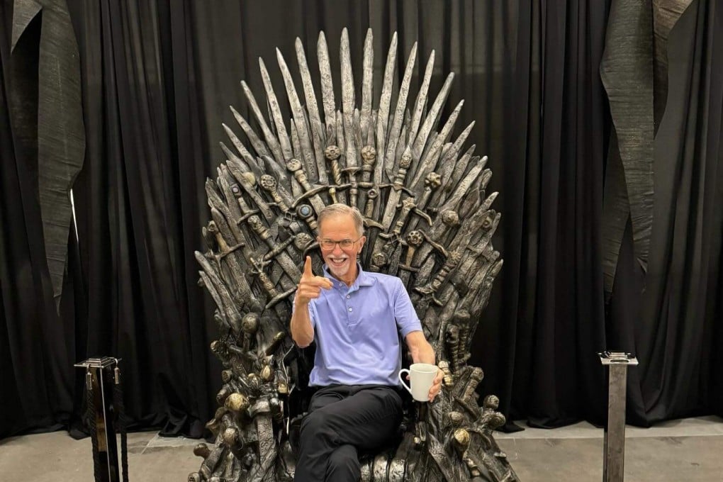 Heritage Auctions chief executive officer Steve Ivy sits on the moulded plastic replica of the Iron Throne from Game of Thrones before its sale for US$1.49 million. Photo: Facebook/Heritage Auctions