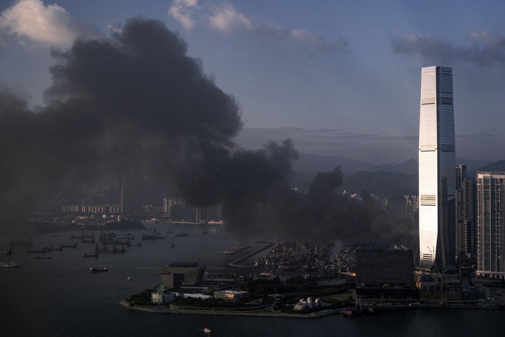Thick smoke billows into the sky from the Yau Ma Tei cargo working area. Photo: Robert Ng