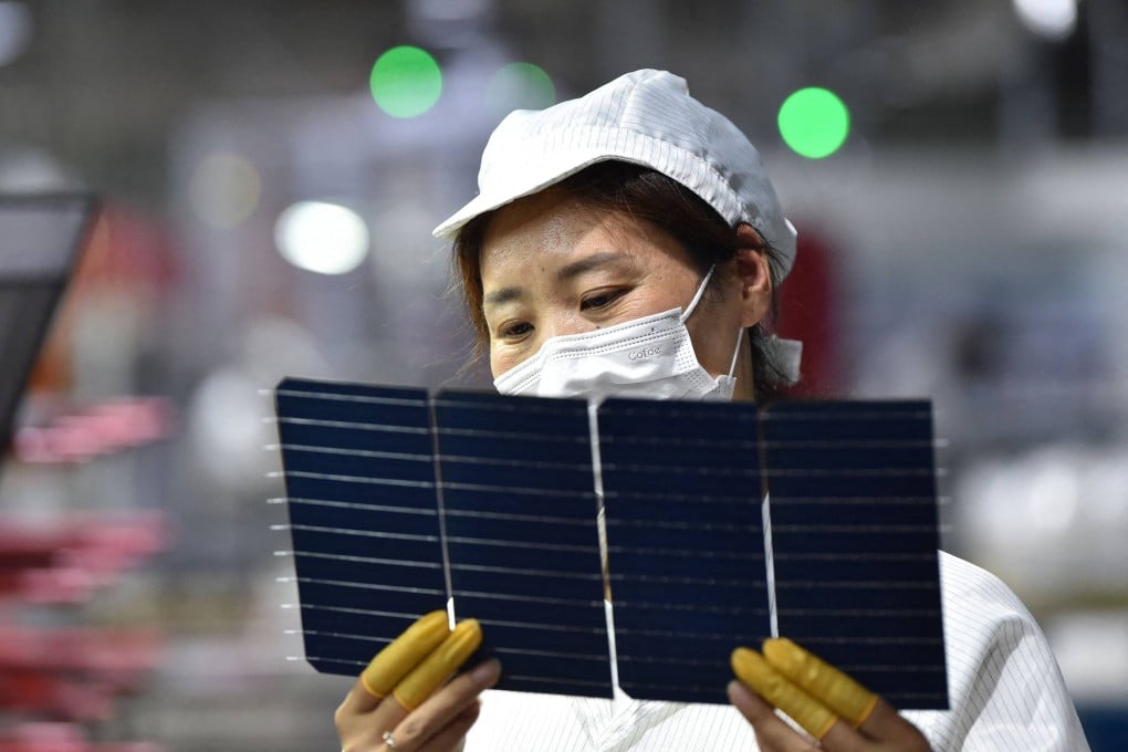 A worker checks solar photovoltaic modules used for solar panels at a factory in Suqian in China’s eastern Jiangsu province. Photo: AFP