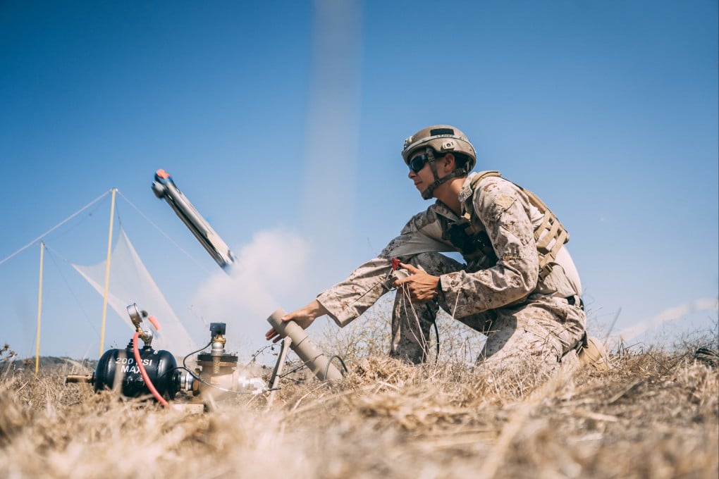 A member of the US Marine Corps launches a Switchblade 300 drone during a drill in California in September 2020. Photo: Marine Expeditionary Force Information Group