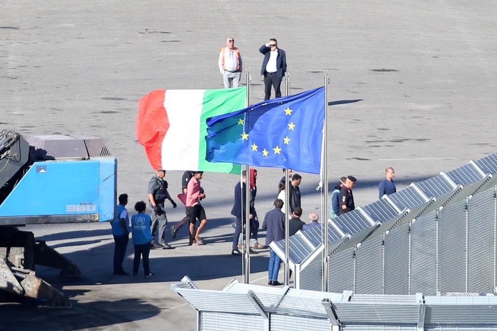 A group of migrants intercepted in Italian waters arrive aboard an Italian navy boat at Shengjin, Albania. Italy has begun sending migrants rescued in the Mediterranean to detention centres in Albania, where their asylum claims will be processed. Photo: EPA-EFE