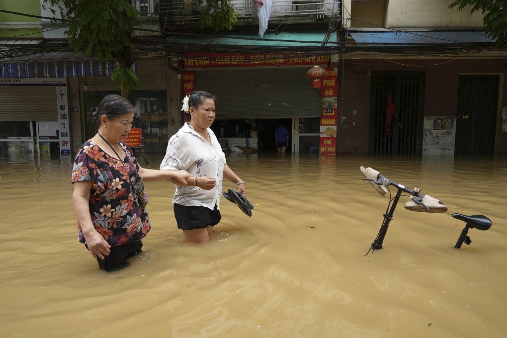 People wade in a flooded street in the aftermath of Typhoon Yagi in Hanoi, Vietnam. Photo: AP