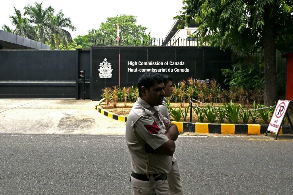 Police personnel walk past the entrance of the Canadian High Commission, in New Delhi, India, on Wednesday. Photo: AFP