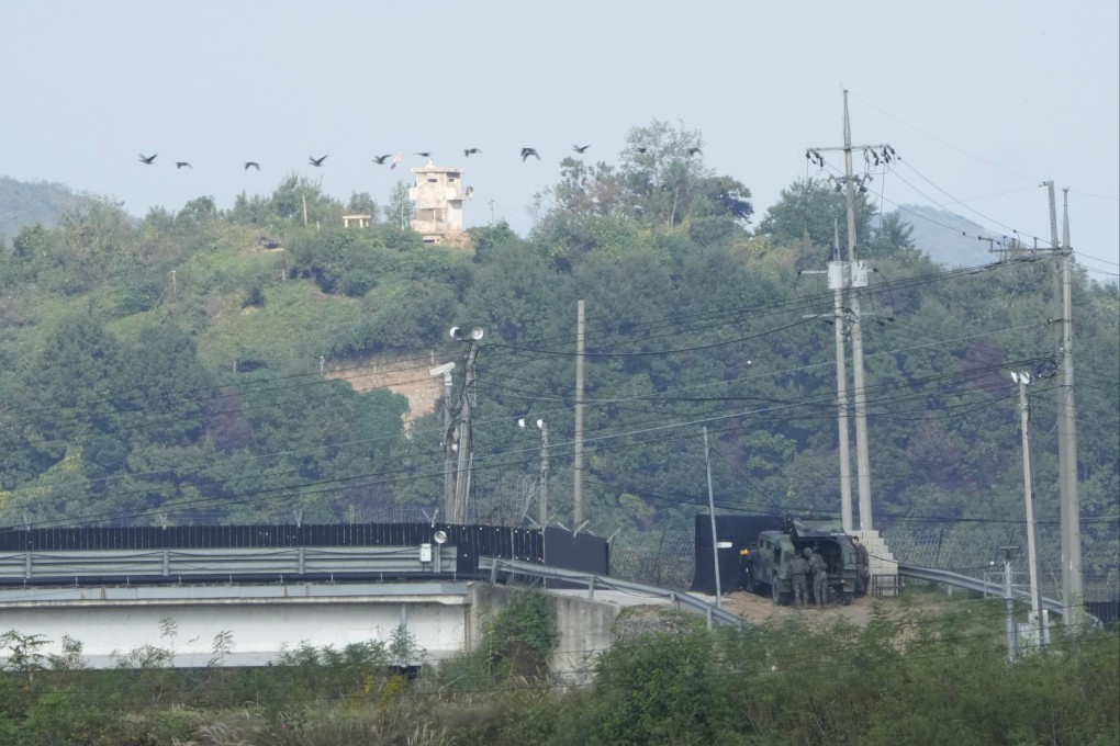 A North Korean military guard post, top, and South Korean army soldiers, bottom, are seen from Paju, South Korea. Photo: AP