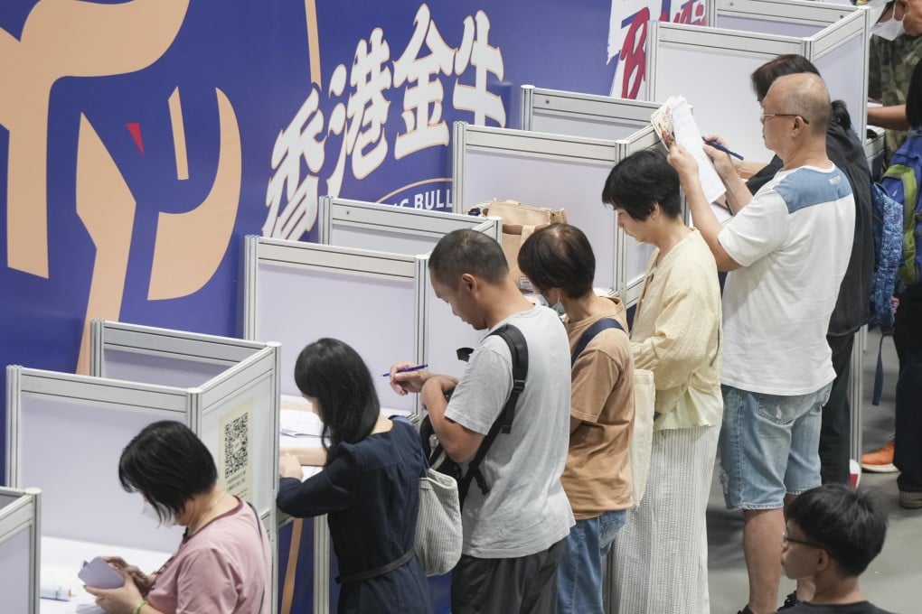 Job seekers looks for work opportunities at an employment fair in Wan Chai. Photo: May Tse