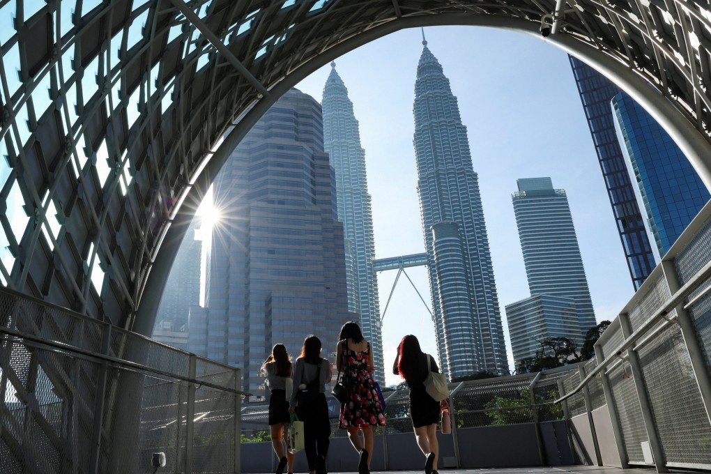 People walk to their workplace during the morning rush at Kuala Lumpur city centre in Malaysia. Photo: Reuters