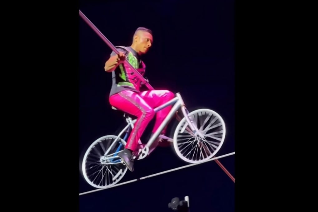 A performer rides a bicycle on a high wire in a promotional video for the Great British Circus. Photo: Facebook/GreatBritishCircusMalaysia