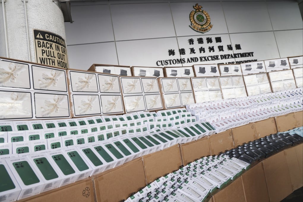 Customs displays the seized mobile phones, tablets and smartwatches. Photo: Jelly Tse