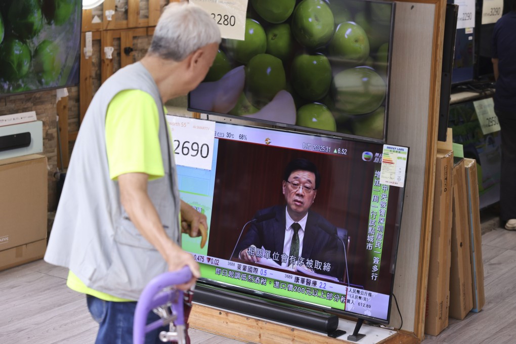 An elderly resident watches a live broadcast of Chief Executive John Lee’s policy address on TV in Sham Shui Po. Photo: Nora Tam