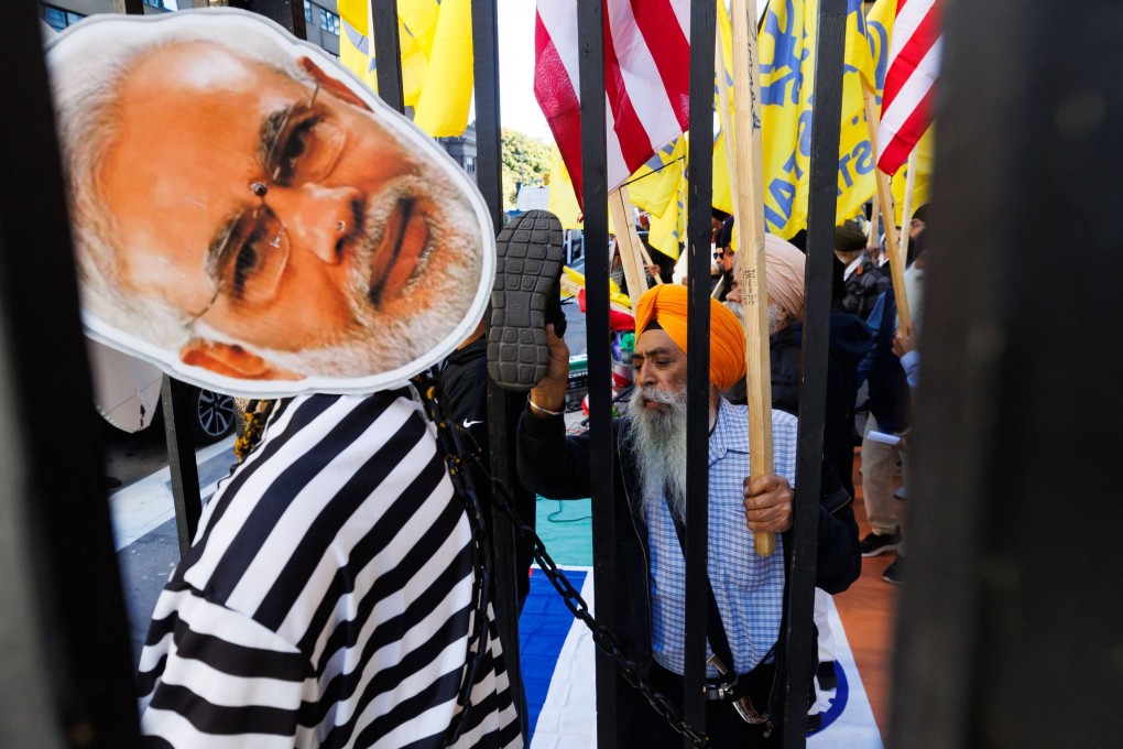 Sikh separatist activists with the Khalistan movement deface a placard and mannequin of Indian Prime Minister Narendra Modi as they protest outside the Consulate General of India in Toronto on Friday. Photo: AFP