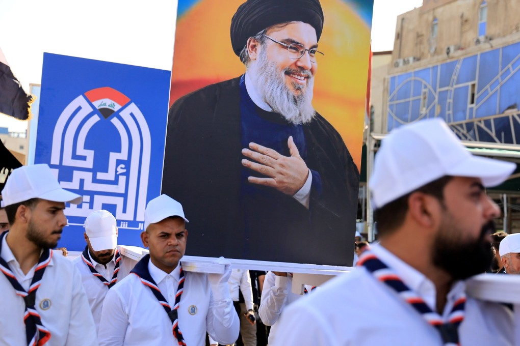 Iraqis carry images of the late Hezbollah leader Hassan Nasrallah during an anti-Israel rally in Karbala, south of Baghdad on Friday. Photo: EPA-EFE