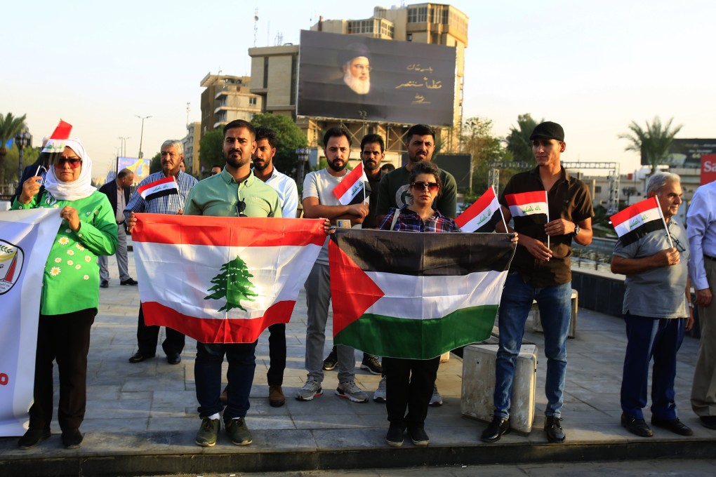 Iraqi activists hold the Palestine and Lebanon flag during a gathering at Al-firdos square in central Baghdad, Iraq, on Friday. Dozens of activists gather in central Baghdad to denounce the ongoing Israeli military strikes and operations in both Lebanon and the Gaza Strip. Photo; EPA/EFE