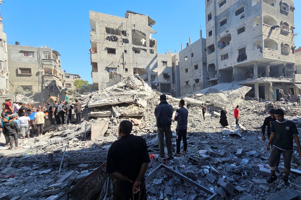 Palestinians gather at the site of Israeli strikes on homes in Beit Lahiya in the northern Gaza Strip on Sunday. Photo: Reuters