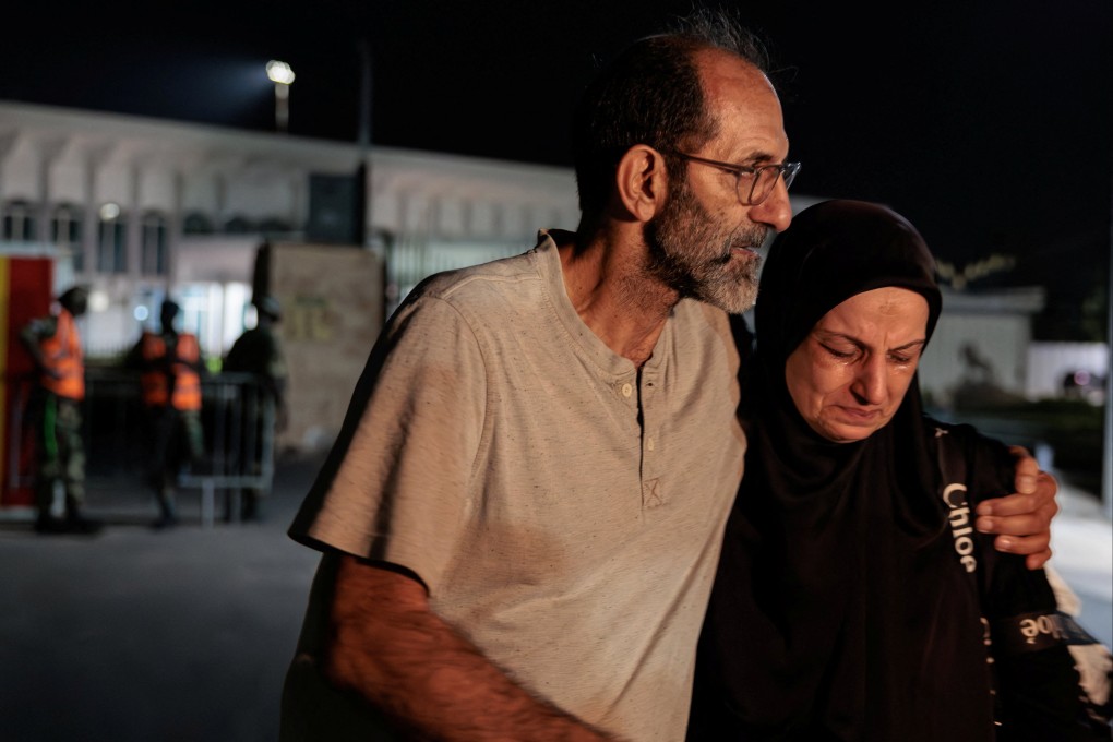 Hussein Hachem hugs his wife Hala after she arrives on a repatriation flight in Dakar, Senegal, on Saturday. Their son, 14, was killed in an Israeli strike on Lebanon. Photo: Reuters