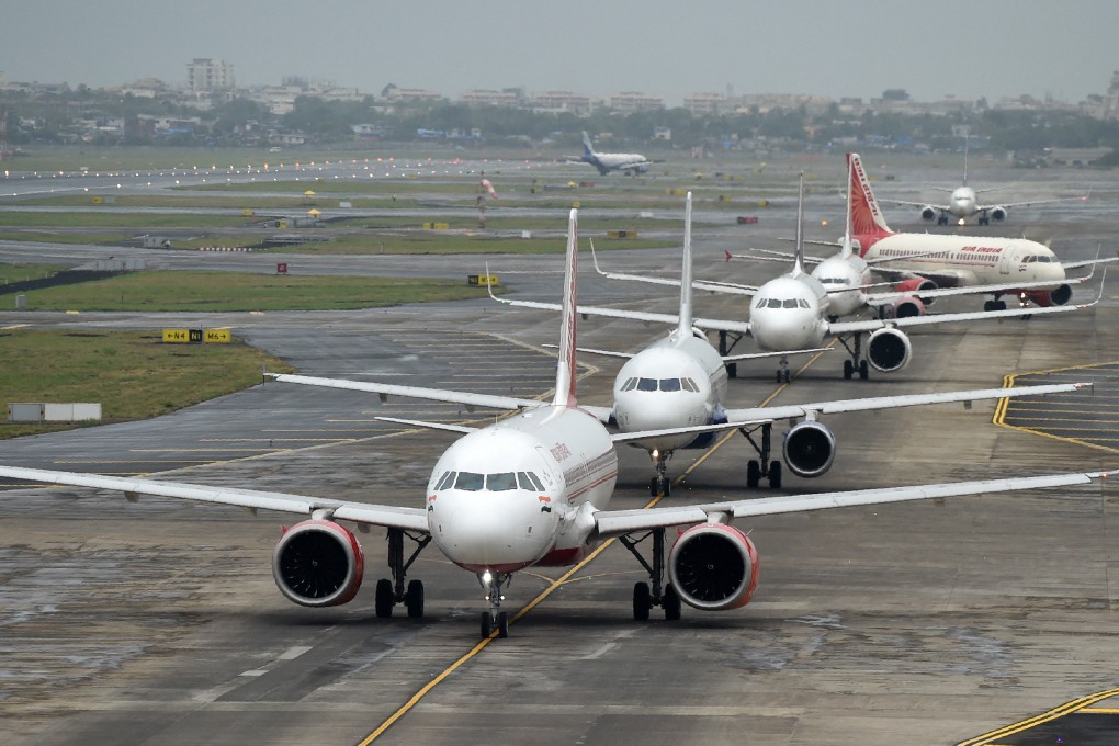 Planes queue up on the tarmac before taking off at an airport in Mumbai, India. Photo: AFP