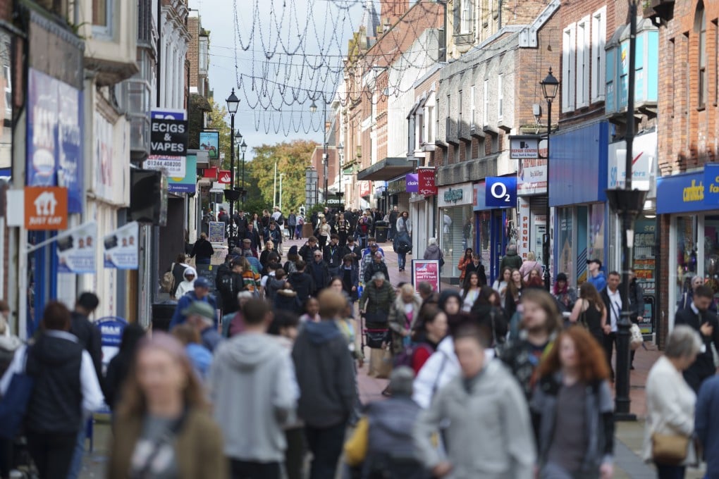 Members of the public walk through the centre of Wrexham, in Wales, on October 7, 2024. Supported by PR from Ryan Reynolds and Rob McElhenney, Wrexham is bidding to become the UK City of Culture for 2029, despite only gaining city status in 2022. Photo: AP