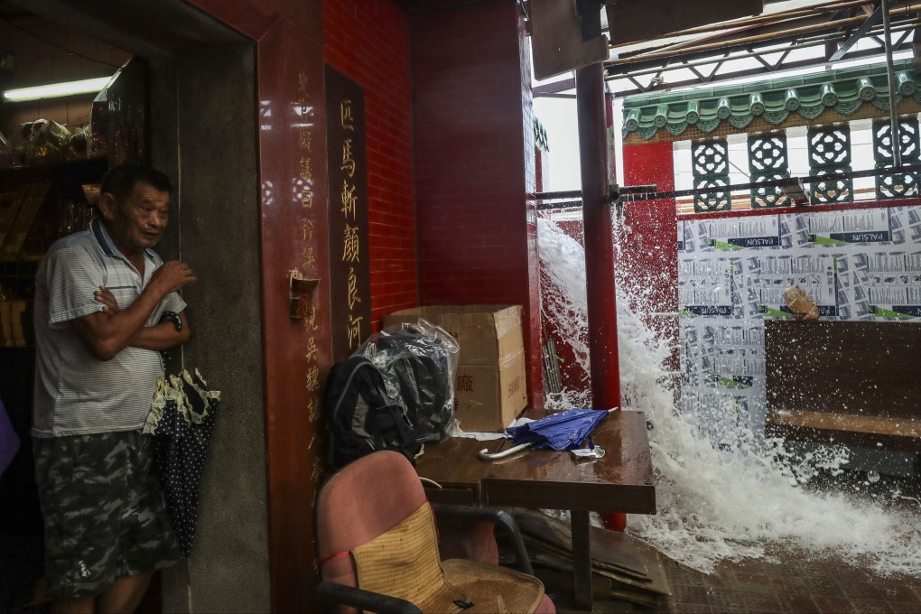 A resident takes shelter at Tin Hau Temple amid strong winds and flooding caused by Typhoon Mangkhut, on September 16, 2018. Photo: Winson Wong