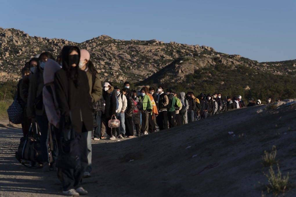 Chinese migrants wait to be processed after crossing the US-Mexican border on May 8, 2024, near Jacumba Hot Springs, California. Photo: AP