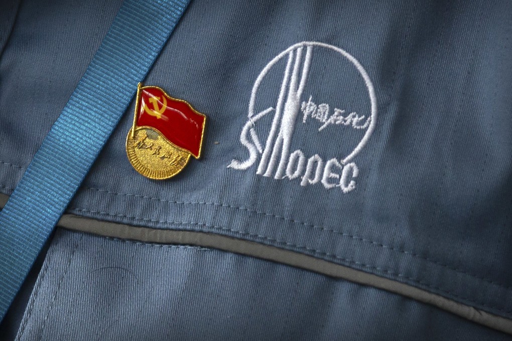 A Chinese Communist Party badge is seen pinned to a worker’s uniform at a Sinopec facility near Beijing in 2018. Photo: AP