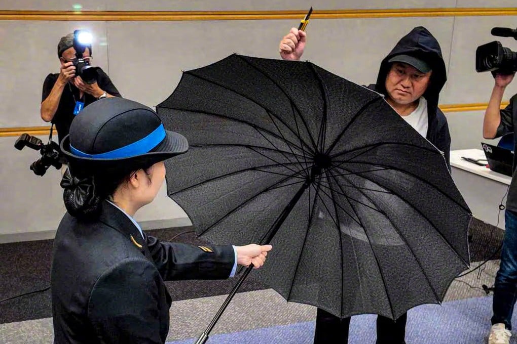 West Japan Railway Co (JR West) demonstrating the new blade-proof umbrellas during a press conference at its headquarters in Osaka on Thursday. Photo: Weibo / Weapon-XN