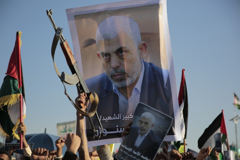 Houthi supporters raise a poster of Hamas leader Yahya Sinwar, who was killed by Israeli troops in Gaza, during an anti-Israel rally in Yemen on October 18, 2024. Photo: AP