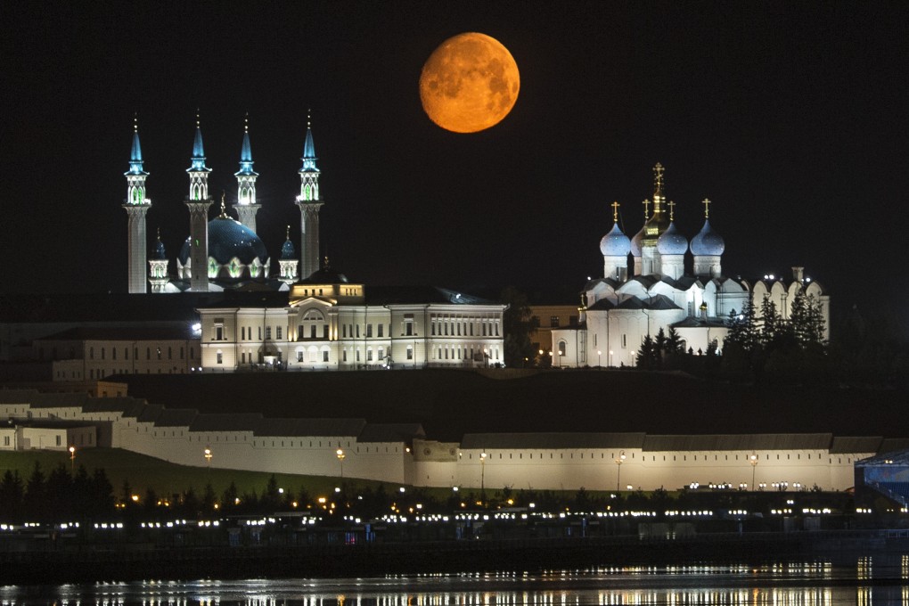 The full moon rises over the Kazan Kremlin in between the Qol Sharif mosque (left) and the Cathedral of the Transfiguration (right) in Kazan, Russia. The city, about 700 km east of Moscow, is hosting this year’s Brics summit, the first with an expanded membership. Photo: AP